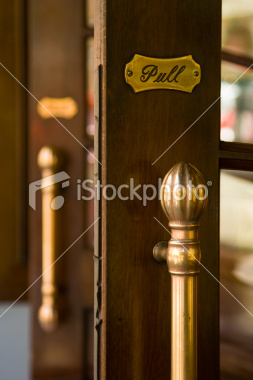 ist2_7399948-classic-wood-framed-doors-with-golden-handle-and-pull-sign